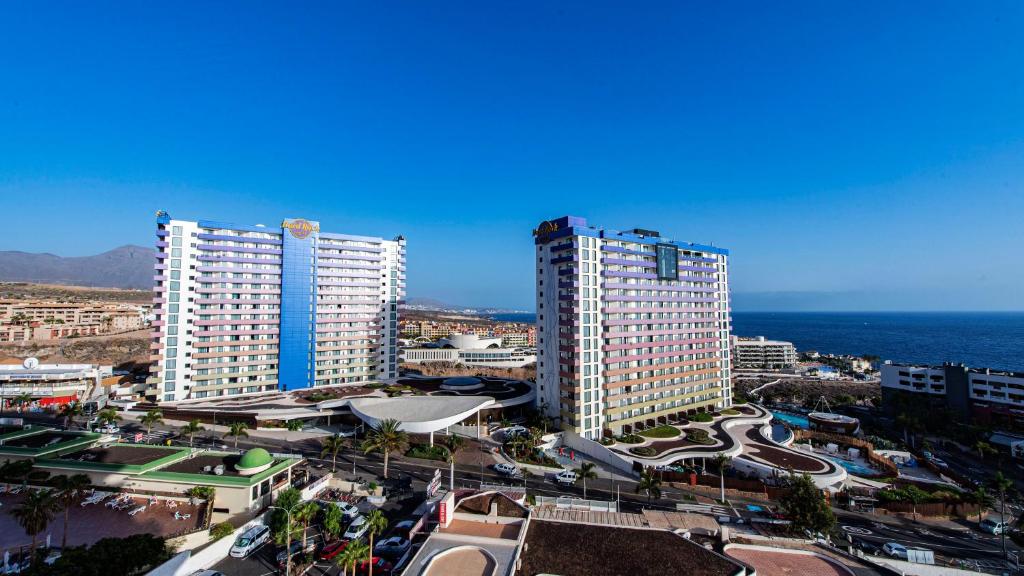 two tall buildings in a city next to the ocean at PANORAMIC VIEW Playa Paraíso in Adeje