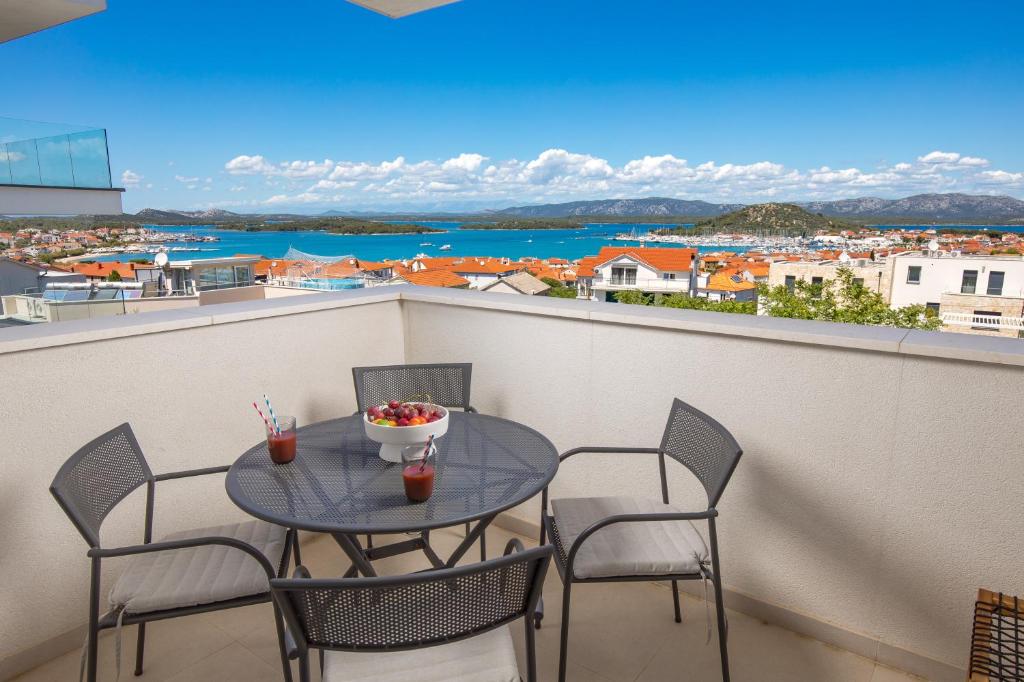 a table and chairs on a balcony with a view at Luxury apartment Mon Soleil 2 in Murter