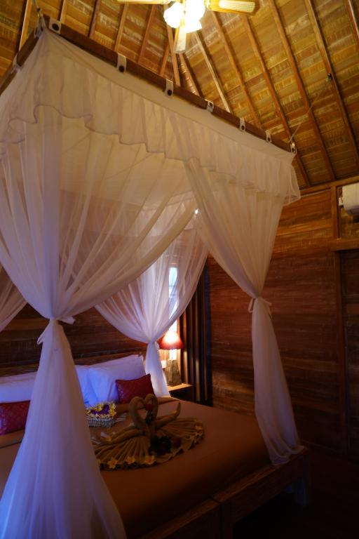 Postel nebo postele na pokoji v ubytování LASTANA SUITE UBUD