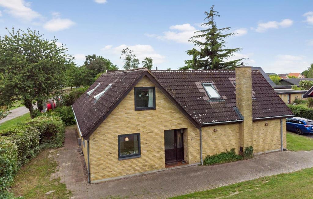 a small yellow house with a brown roof at Pet Friendly Home In Bandholm With Wifi in Bandholm