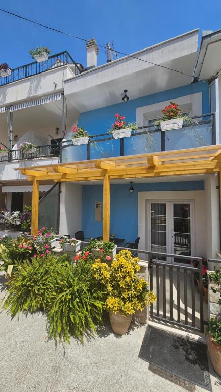 a building with a bunch of flowers in front of it at Goga Luxury two Levels Apartment in Seget Vranjica