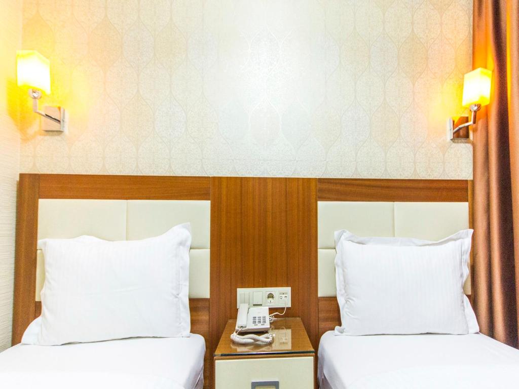Postel nebo postele na pokoji v ubytování Mint Residence Taksim