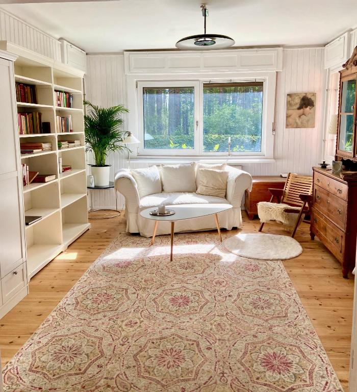 a living room with a couch and a table at Studio im Haus Amselgarten in Kolonie Tannenhof