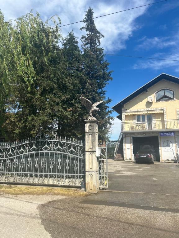 a gate with a bird statue in front of a house at Astralis Factory Apartments- FLY in Zagreb