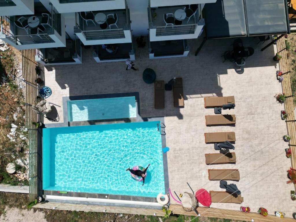 an overhead view of a pool with a person in the water at Noa Boutique Hotel in Ksamil