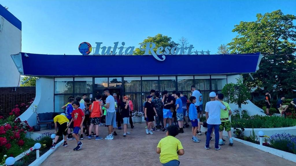 a group of people standing outside of a building at Hotel Iulia Resort in Venus
