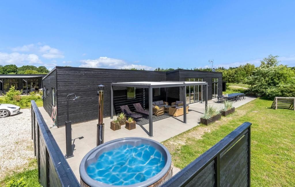 a house with a swimming pool and a hot tub at Lovely Home In Glesborg With Wifi in Glesborg