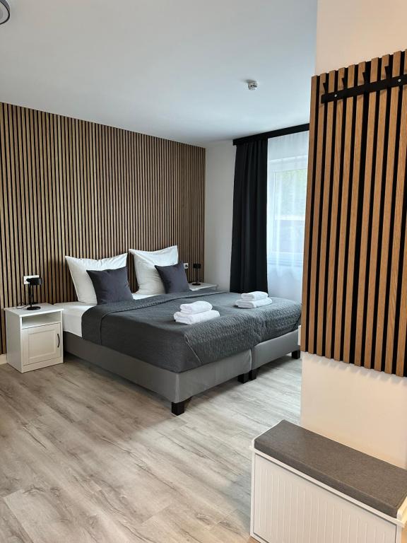 a bedroom with a bed and a large window at Lagom - Apartments an der Barclays Arena in Hamburg