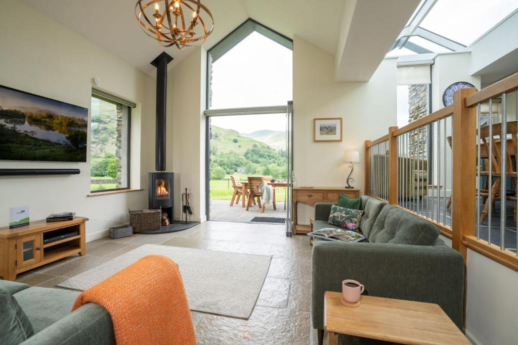 a living room with a couch and chairs and a fireplace at Panoramic Views & Spacious Living by LetMeStay in Grasmere