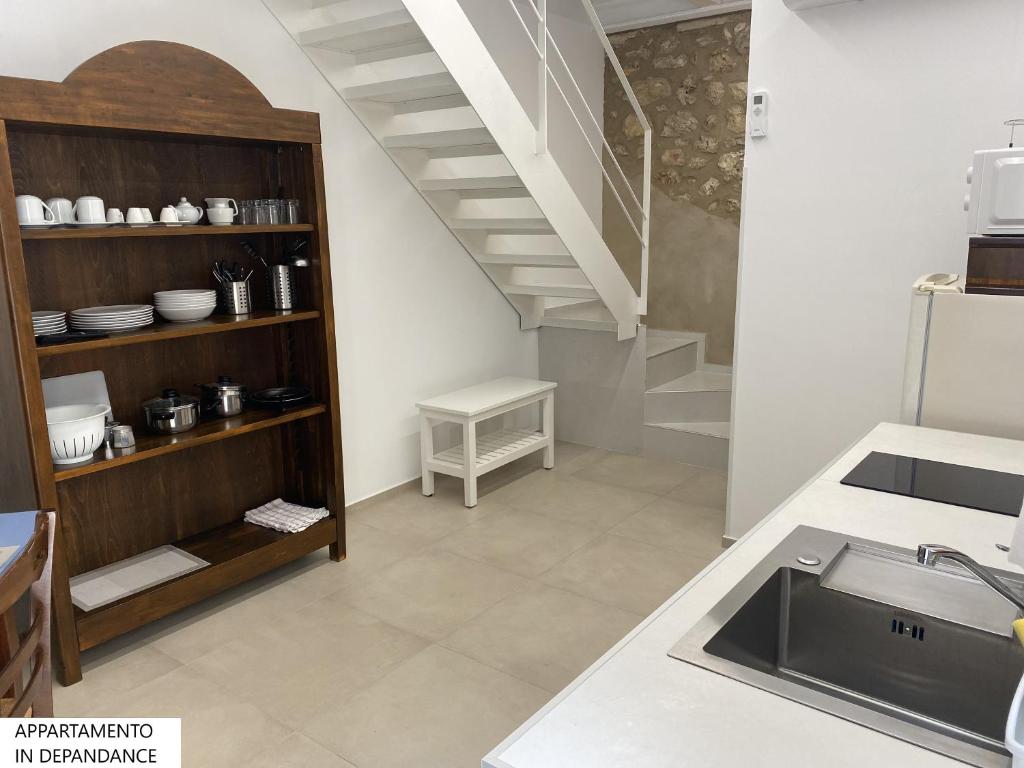 a kitchen with a sink and a staircase at Tenute Plaia Agriturismo in Scopello