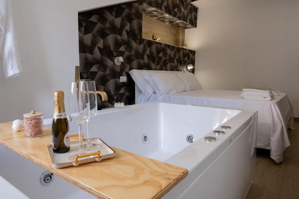 a white bath tub in a room with a bed at Coraline Deluxe Rooms in Castellammare di Stabia