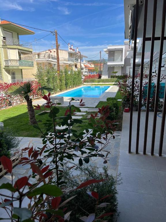 a swimming pool in a yard next to a building at Perla 2 Paralia Ofriniou in Ofrínion