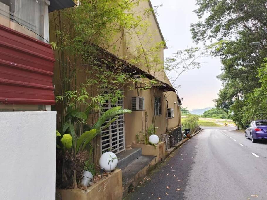 a building with plants on the side of a street at Hill Top 2StoreyHouse BktAntarabangsa,Free Unlimited Parking in Ampang