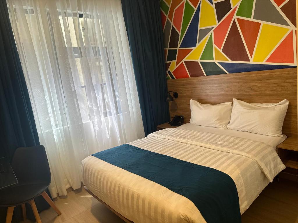 Postel nebo postele na pokoji v ubytování Hotelinn Oniru
