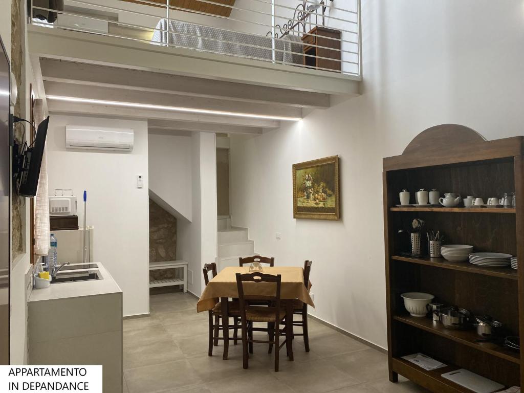 a kitchen and dining room with a table and chairs at Tenute Plaia Agriturismo in Scopello