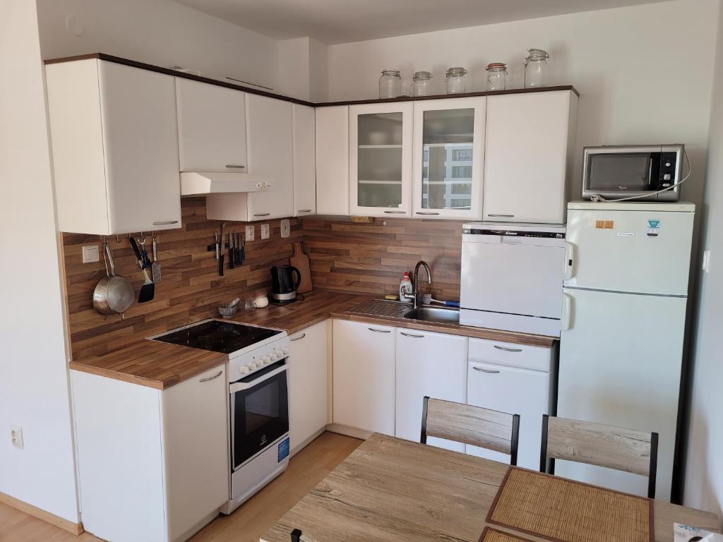 a kitchen with white appliances and white cabinets at Neva Trnava 2 in Trnava