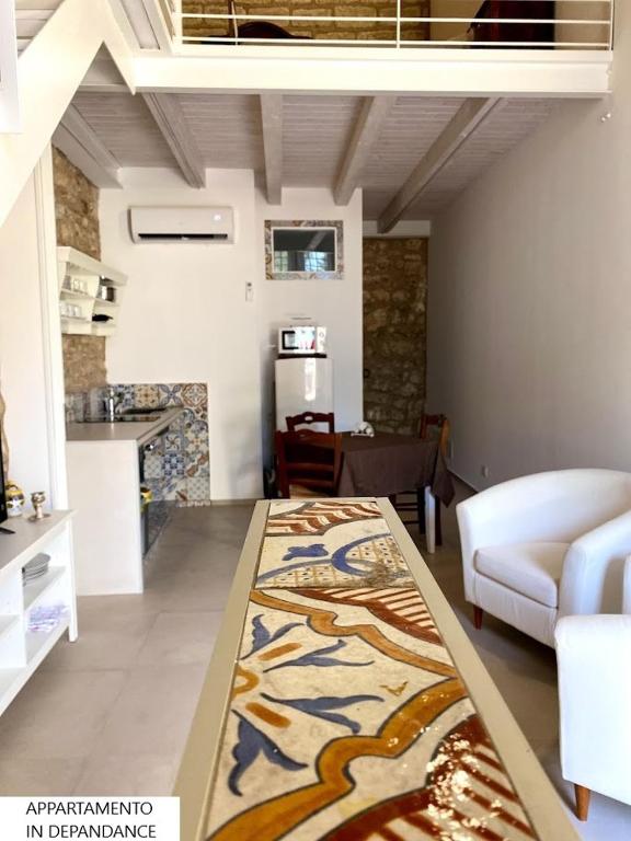 a living room with a table with a rug on the floor at Tenute Plaia Agriturismo in Scopello