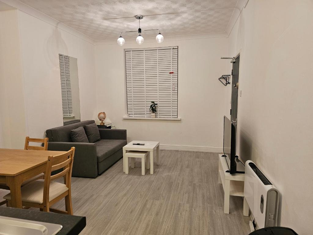 ブリジェンドにあるModern & Cosy 1 bedroom flat in Bridgend townのソファとテーブルのあるリビングルーム