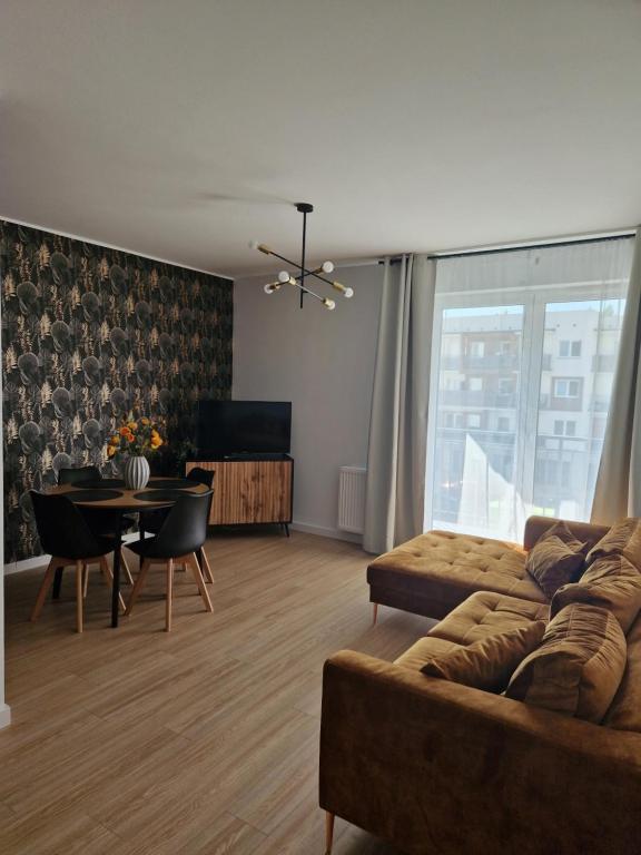 a living room with a couch and a table at Apartament Staromiejski Rapackiego 45 in Grudziądz