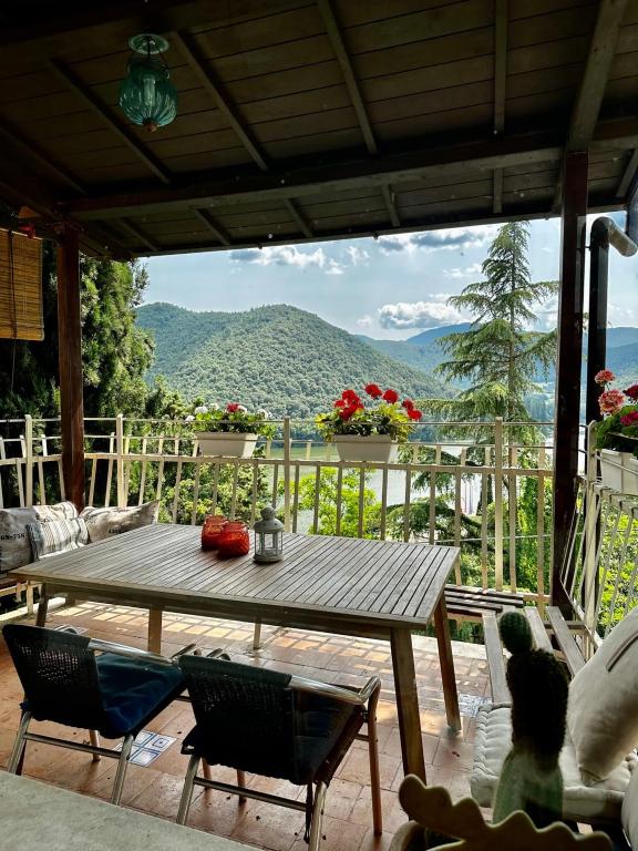a wooden table on a patio with a view of a mountain at Villa bianca in Piediluco