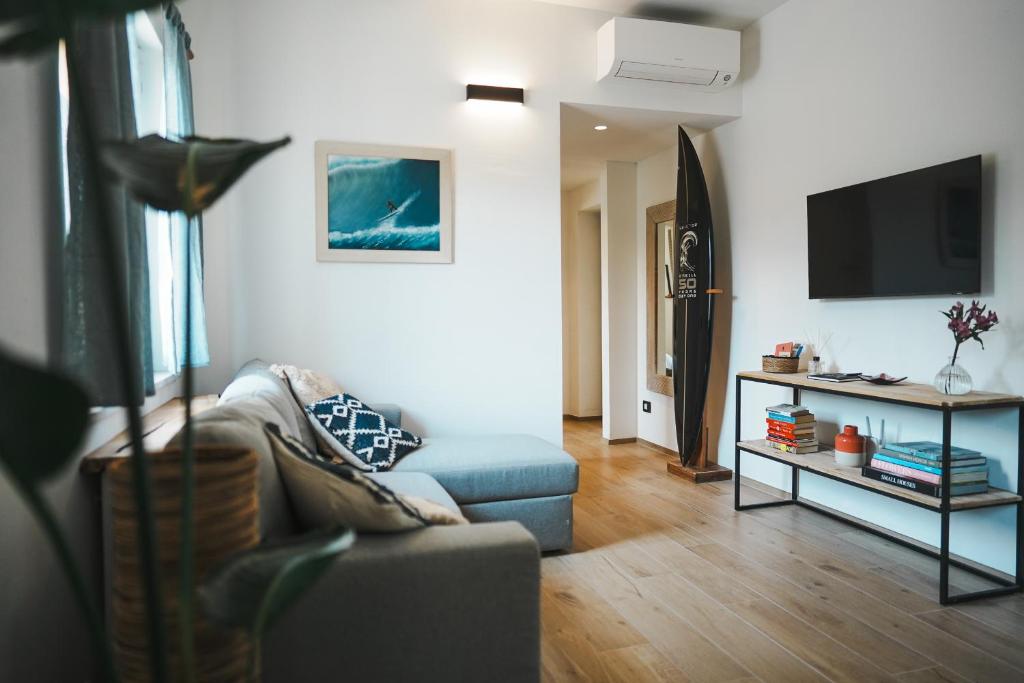 a living room with a couch and a tv at surf house in Nago-Torbole