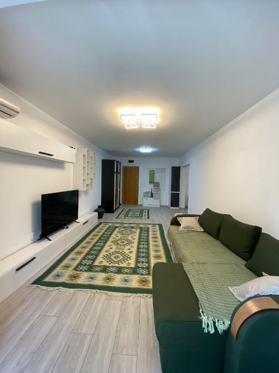 a living room with a couch and a television at M&M apartment in Tulcea