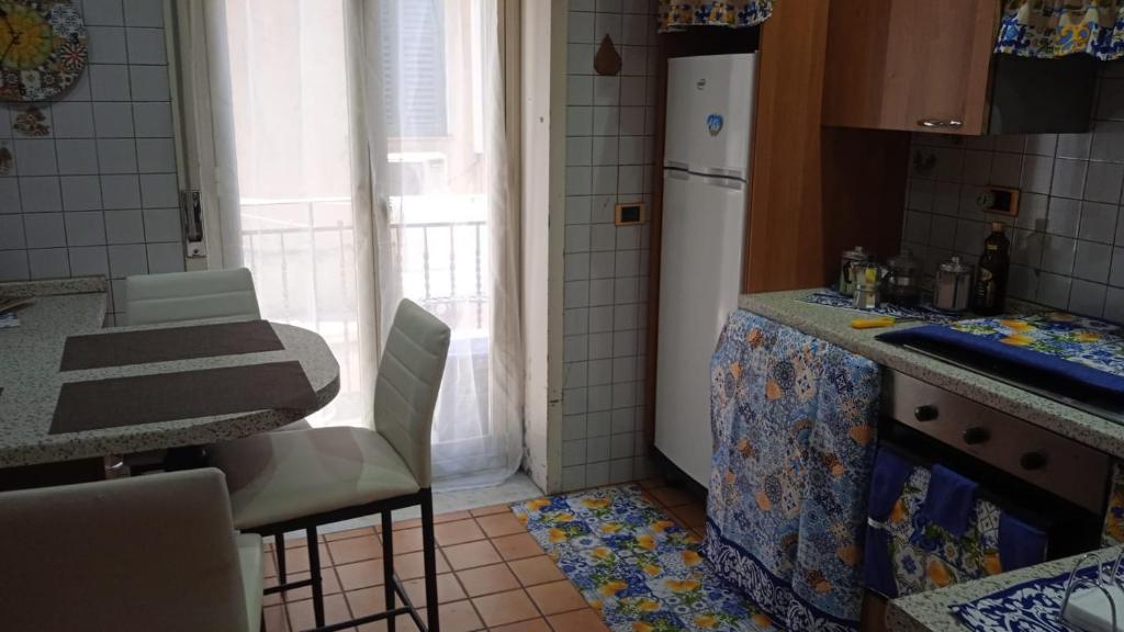 a kitchen with a counter and a refrigerator in it at Sole Urbano in Messina