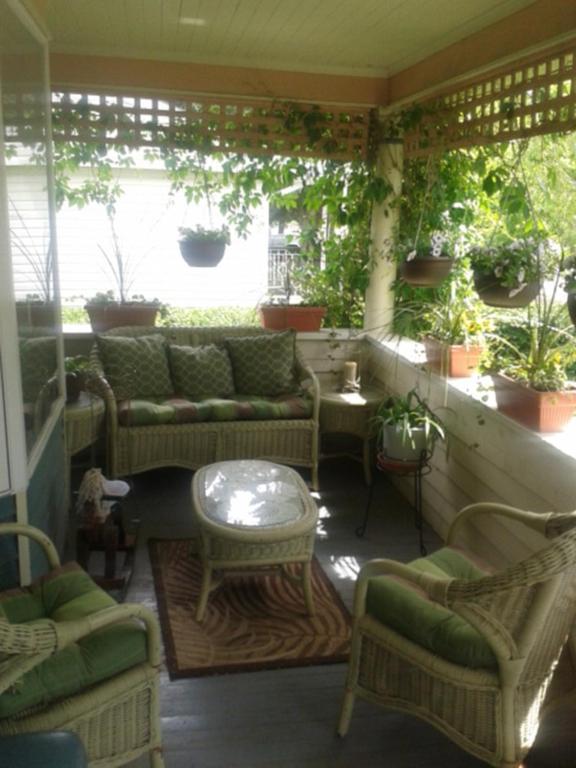 a patio with couches and a table and chairs at Phoenix House B&B in Stettler