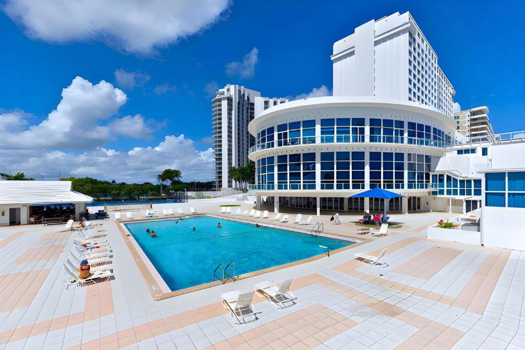 una piscina frente a un edificio en SeaStays ~ Oceanfront Apartments, en Miami Beach
