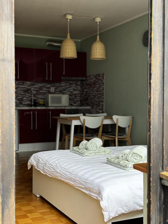 a kitchen with a bed and a table and chairs at Apartment Vita in Bovec