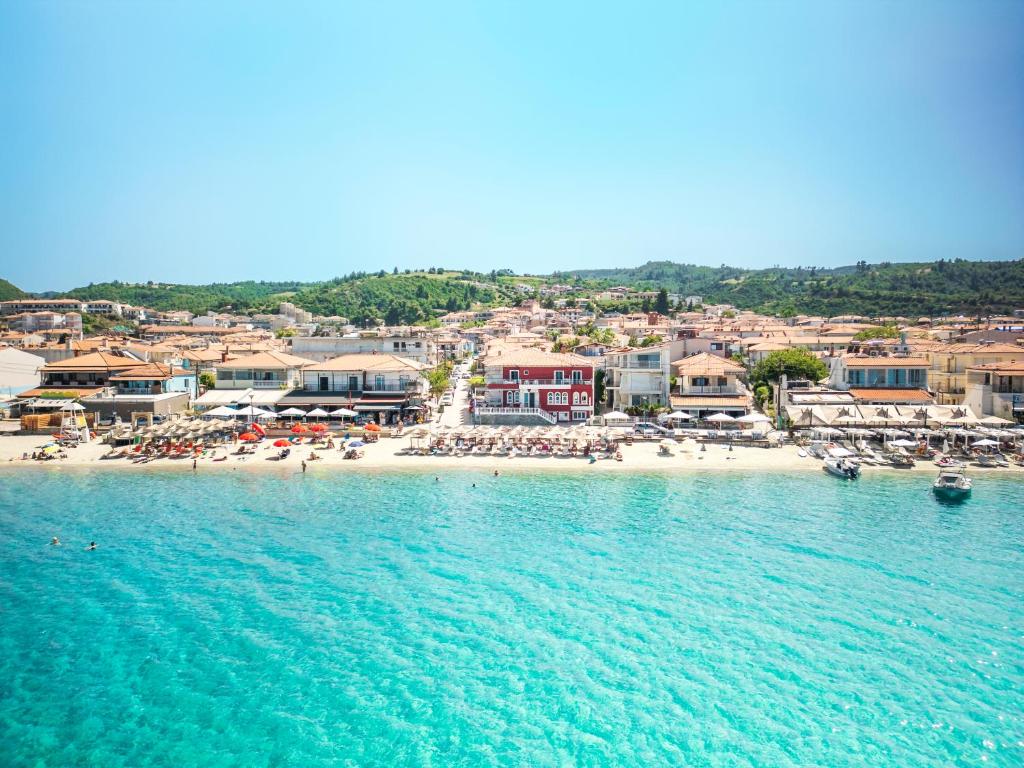a beach with umbrellas and a crowd of people at Summer Beach Hotel in Polychrono