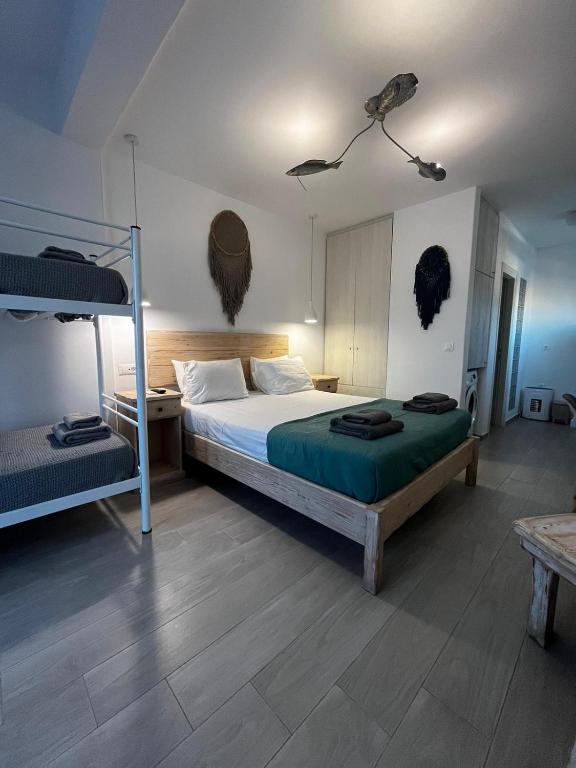 a bedroom with two bunk beds and a table at sun studios in Mikonos