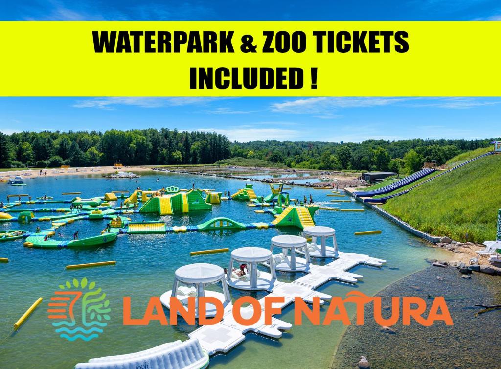 a water park with a bunch of boats in the water at Natura Aloha Beach Resort in Wisconsin Dells