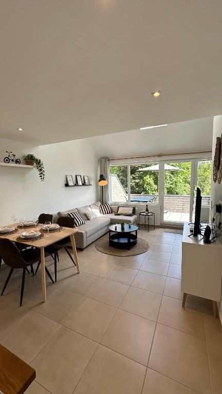 a living room with a couch and a table at Les Terrasses de Malmedy - duplex 430 in Malmedy