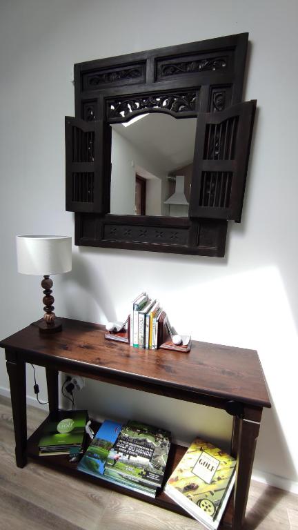 une table en bois avec un miroir sur un mur dans l'établissement Gîte 4 pers L'Ainstant Présent, à Ambérieux-en-Dombes