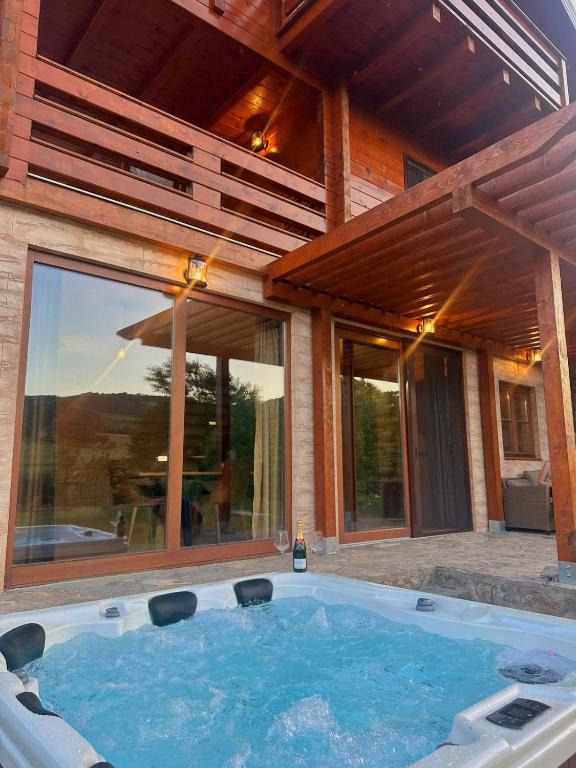 a hot tub in front of a house at Villa Rivera in Banja Luka