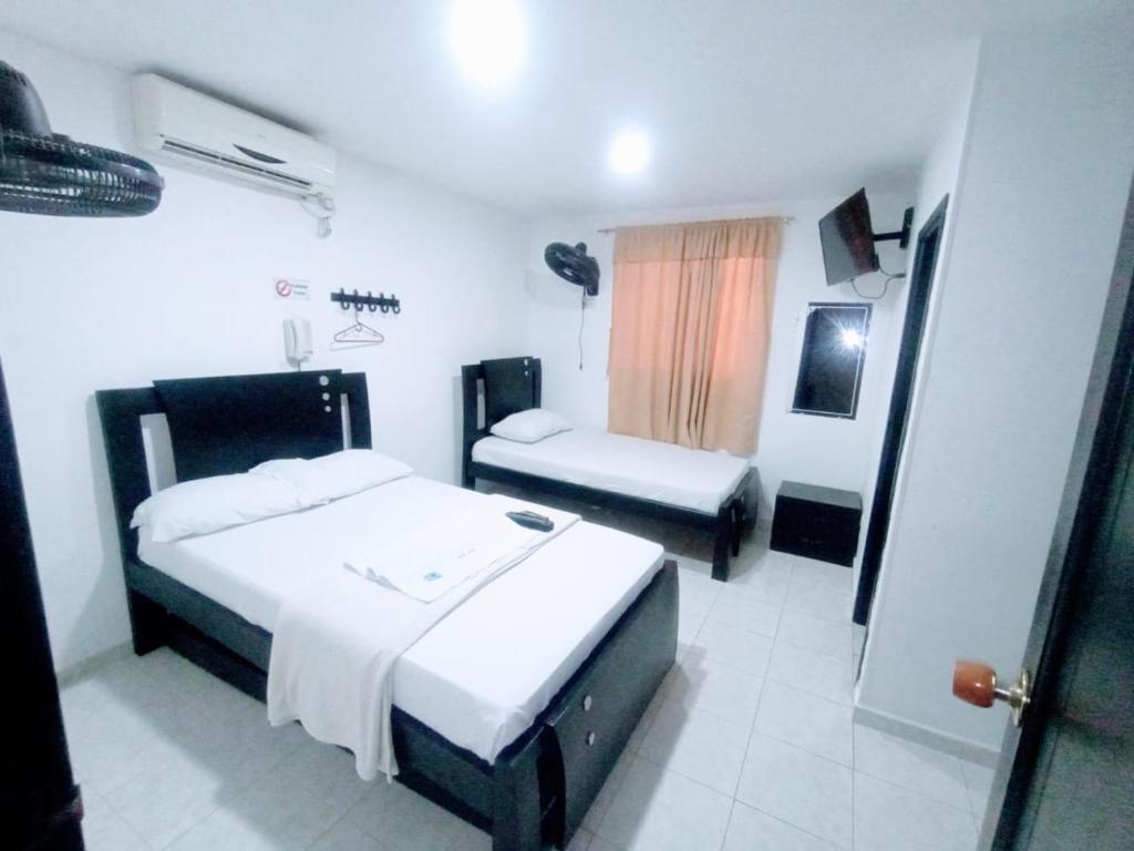 Postel nebo postele na pokoji v ubytování Hotel Jahdai Curumani