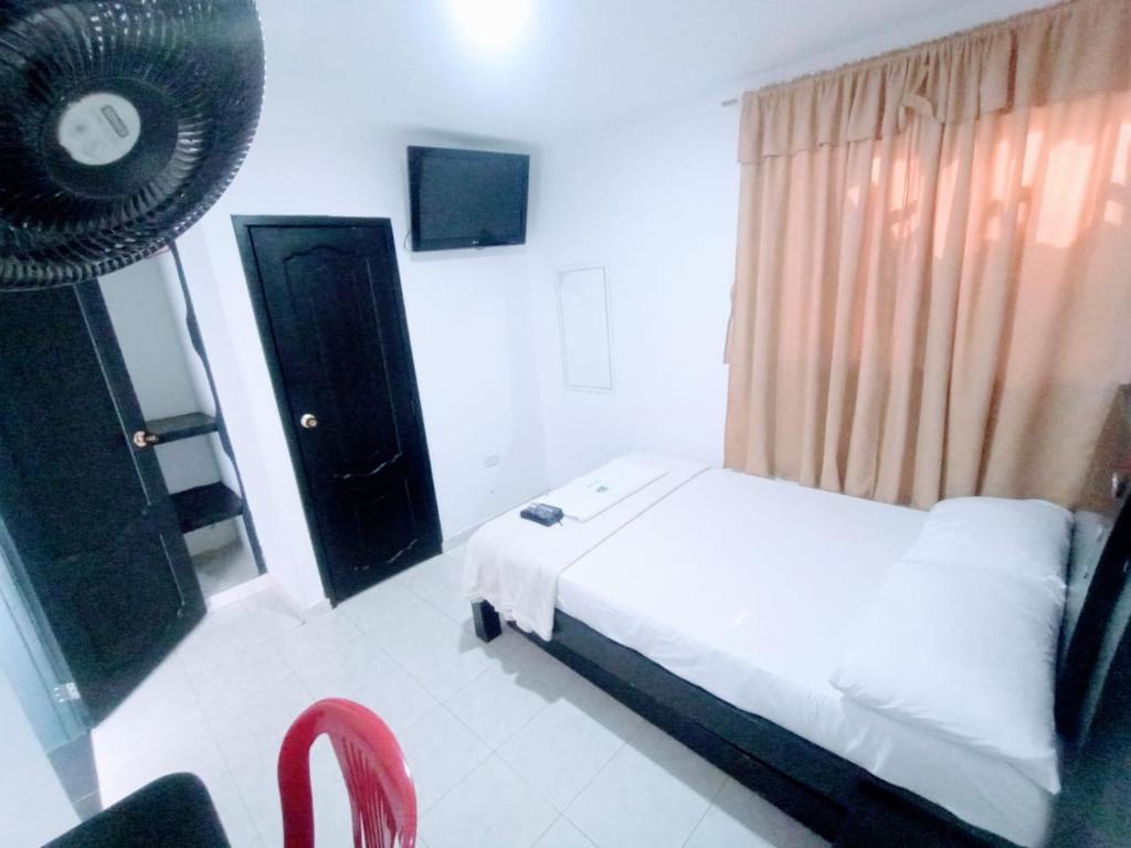 Postel nebo postele na pokoji v ubytování Hotel Jahdai Curumani