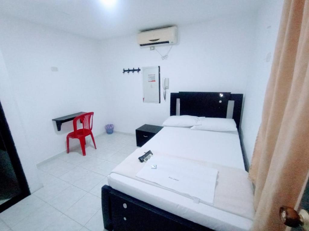 Postel nebo postele na pokoji v ubytování Hotel Jahdai Curumani