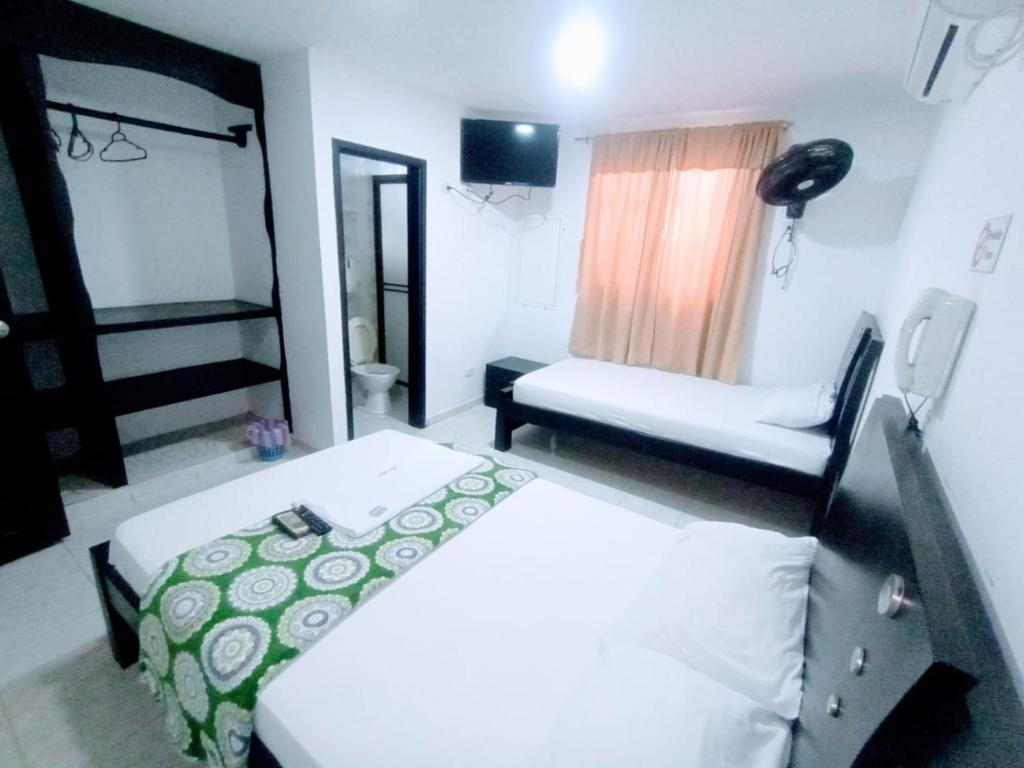 Postel nebo postele na pokoji v ubytování Hotel Jahdai Curumani
