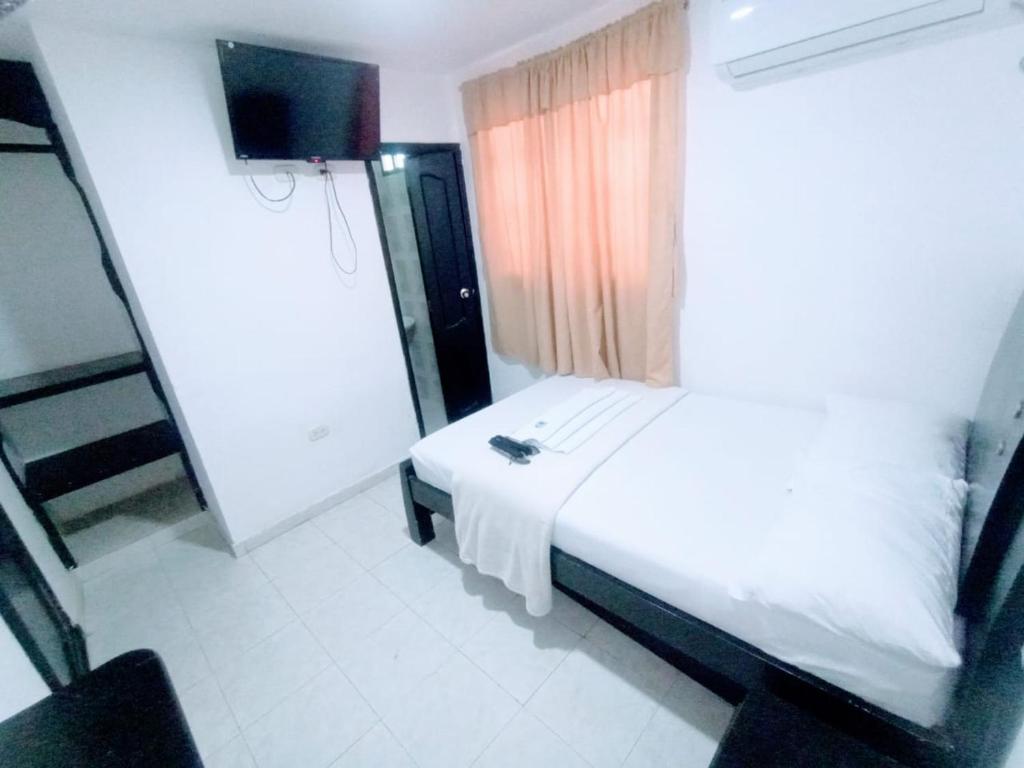 Postel nebo postele na pokoji v ubytování Hotel Jahdai Curumani