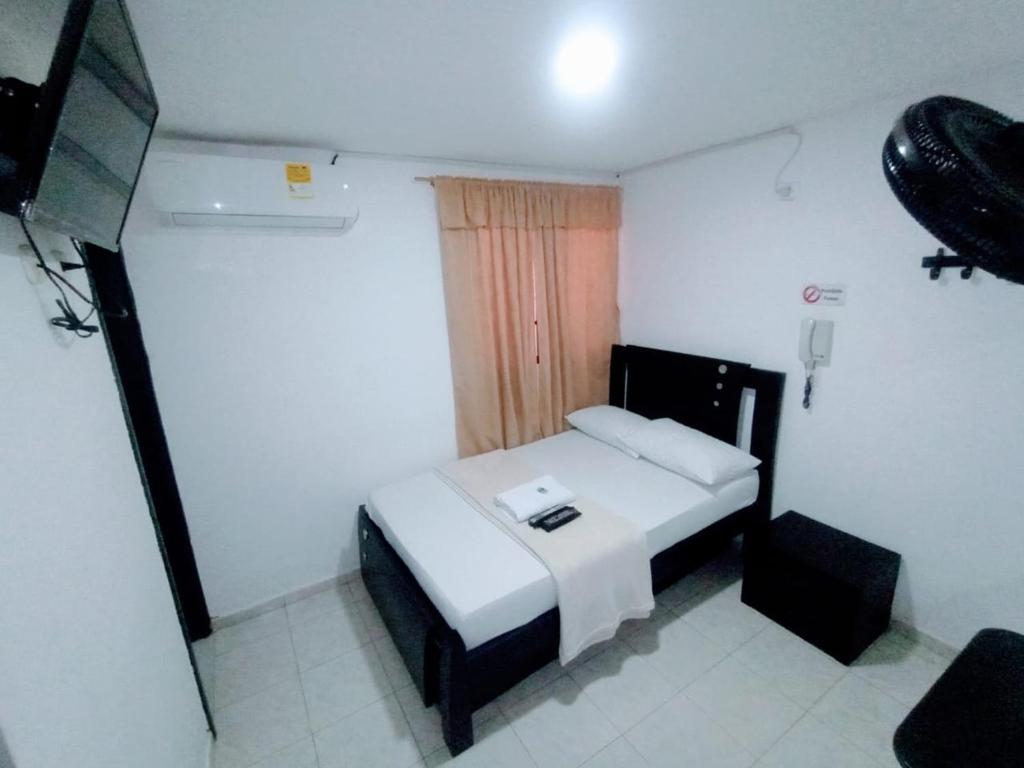 Postel nebo postele na pokoji v ubytování Hotel Jahdai Curumani