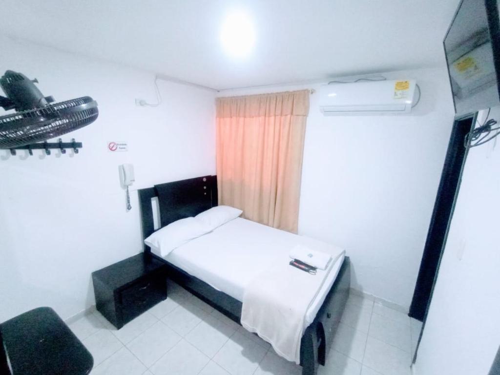 Postel nebo postele na pokoji v ubytování Hotel Jahdai Curumani
