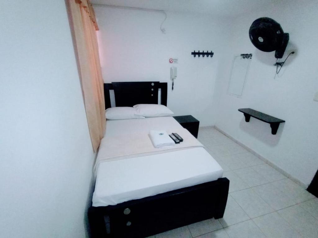 Postel nebo postele na pokoji v ubytování Hotel Jahdai Curumani