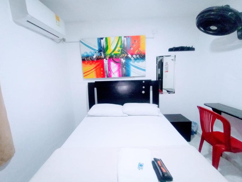 Postel nebo postele na pokoji v ubytování Hotel Jahdai Curumani