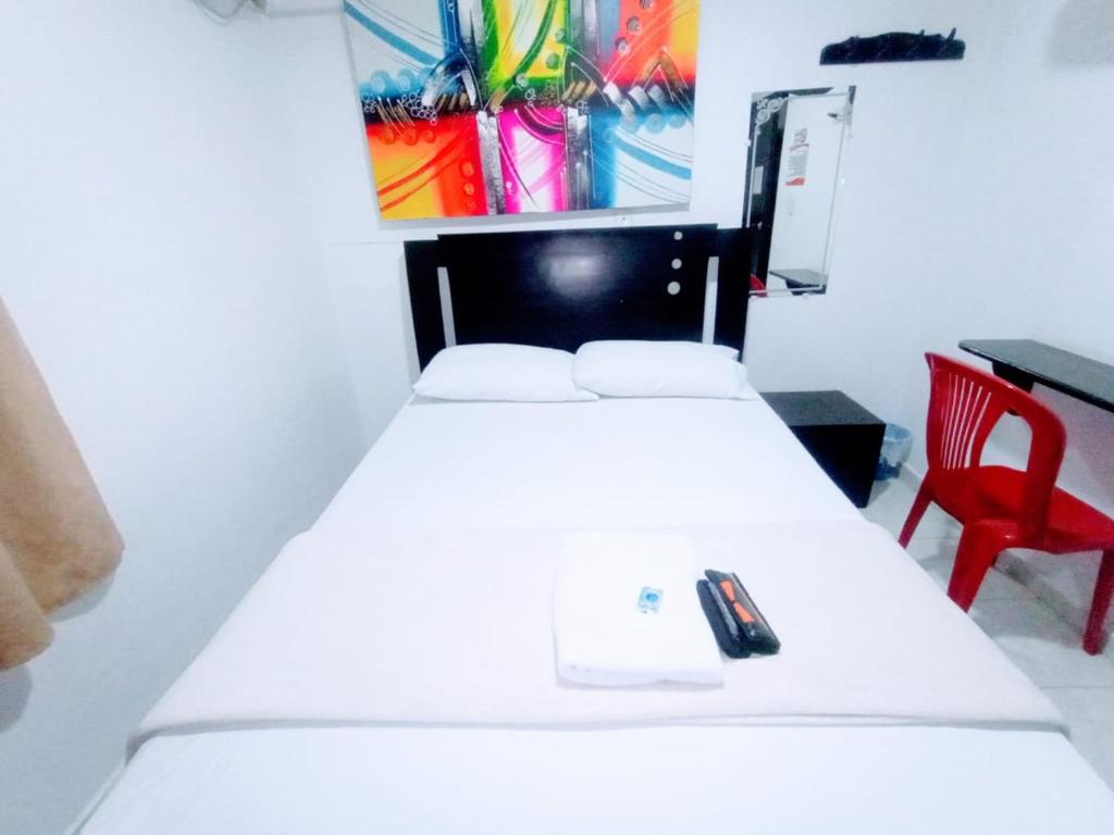 Postel nebo postele na pokoji v ubytování Hotel Jahdai Curumani