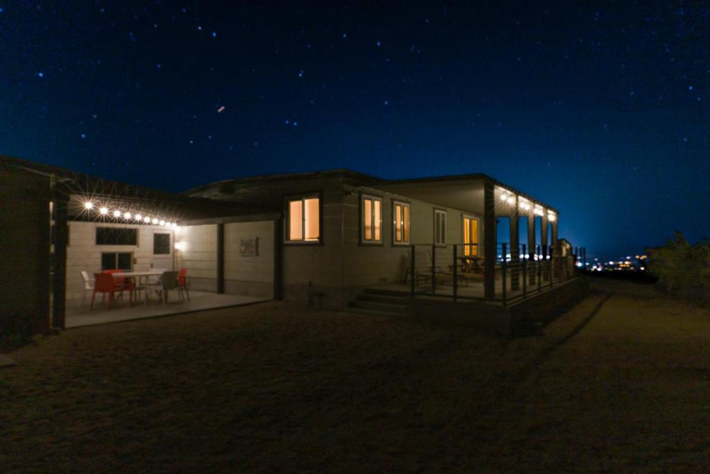a small house at night with lights on it at Roadrunner's Roost in Twentynine Palms