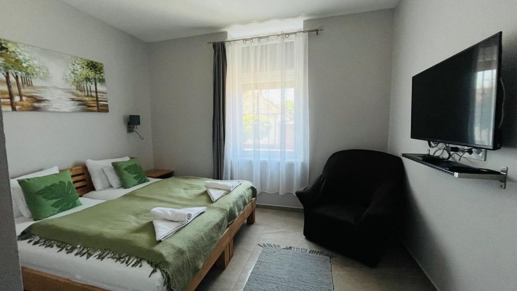 Postel nebo postele na pokoji v ubytování Vitality Apartman
