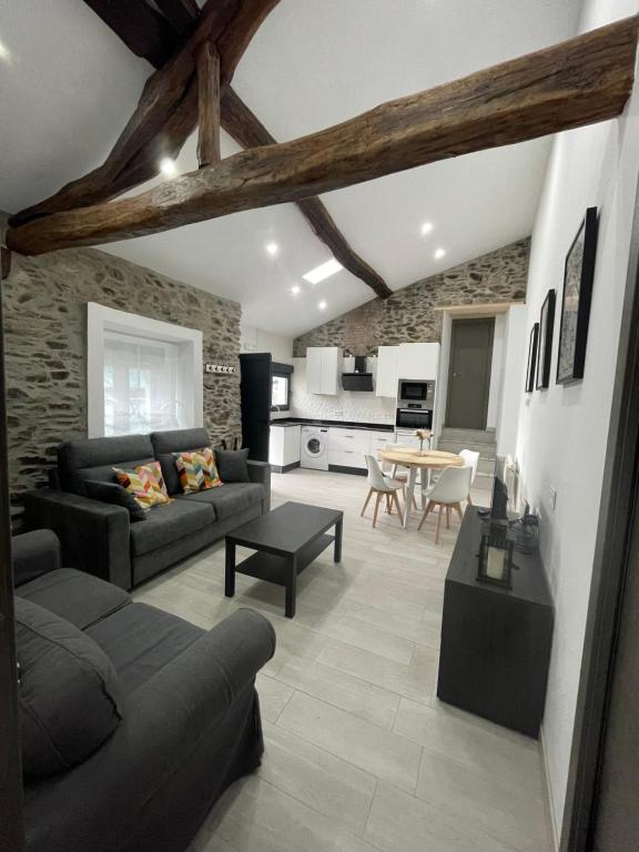 a living room with a couch and a table at CASA SANTI Y LAURA in Cudillero