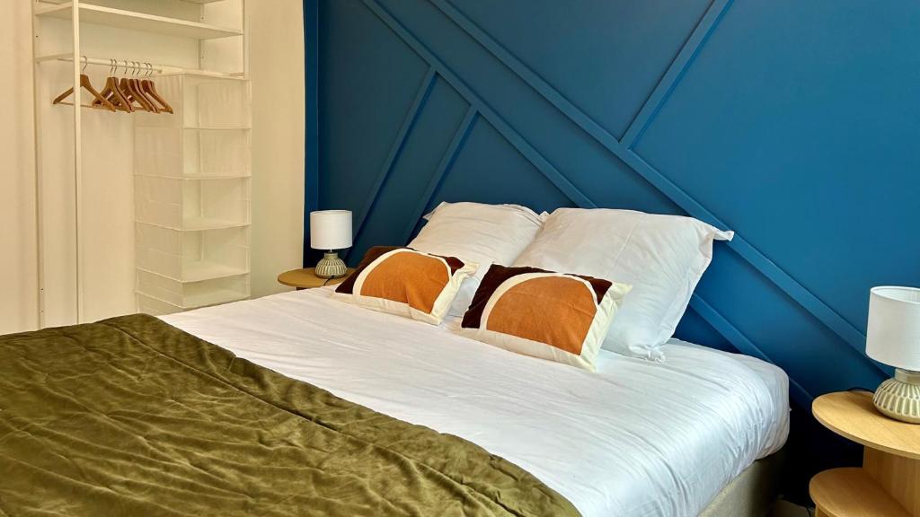 a blue bedroom with a bed with two pillows at Charlie Blue in Nevers